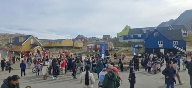 People gather in a square in Tasiilaq