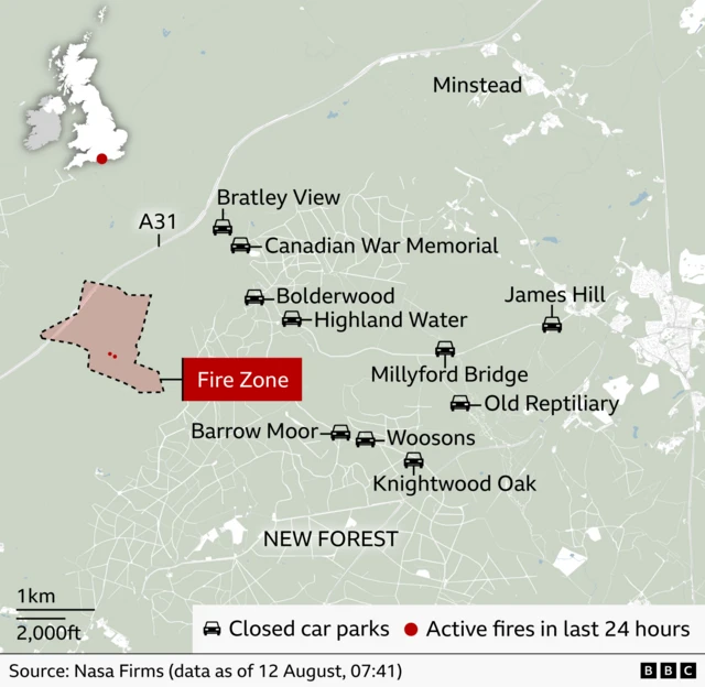 BBC map of the New Forest in southern England showing a marked fire zone west of Bolderwood, near the A31. The fire zone is outlined with a dashed black boundary and shaded pink, with multiple red dots indicating active fires detected in the previous 24 hours. Black car icons mark closed car parks at Bratley View, Bolderwood, Highland Water, Millyford Bridge, Old Reptiliary, James Hill, Barrow Moor, Woosons and Knightwood Oak. An inset map of the UK highlights the New Forest's location on the south coast. Source: NASA FIRMS data (as of 11 August, 03:34).
