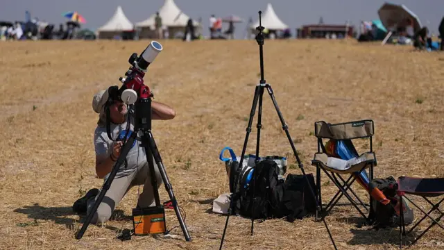 An astronomy enthusiast makes his final adjustments in the hours leading up to the total solar eclipse observation in Lodoso, Burgos province, on August 12, 2026.