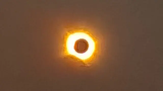 A solar eclipse visible from Benavente, with the Sun glaring around the Moon