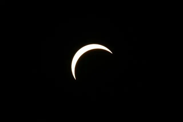 The Moon partially covers the Sun during the solar eclipse as seen from the sidelines of the European Athletics Championships at Alexander Stadium in Birmingham on August 12, 2026