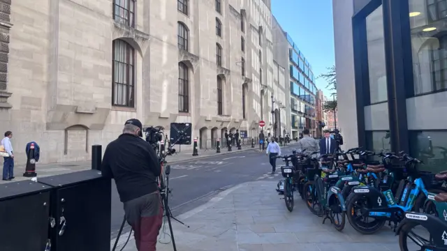 A photo taken outside the Old Bailey, where two camera crews are getting set up