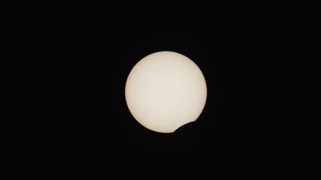 The Sun with a portion of it covered against a black background