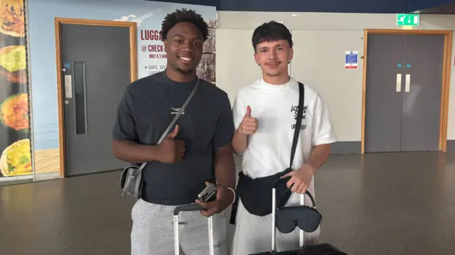 Herbie and Josh pose for pictures at Birmingham Airport