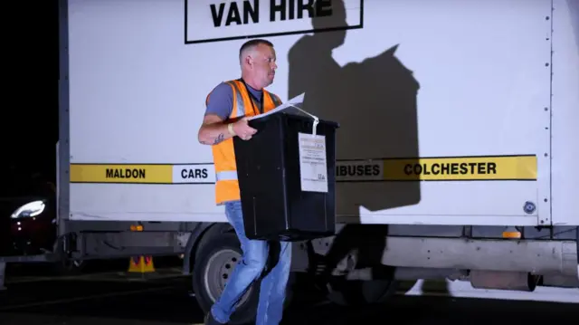 A man carrying a ballot box following the Clacton by-election