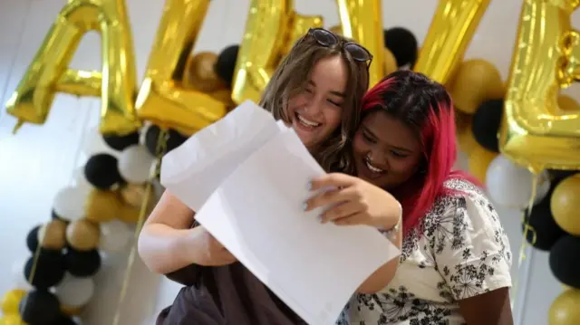Two young women celebrating the opening of their A level results