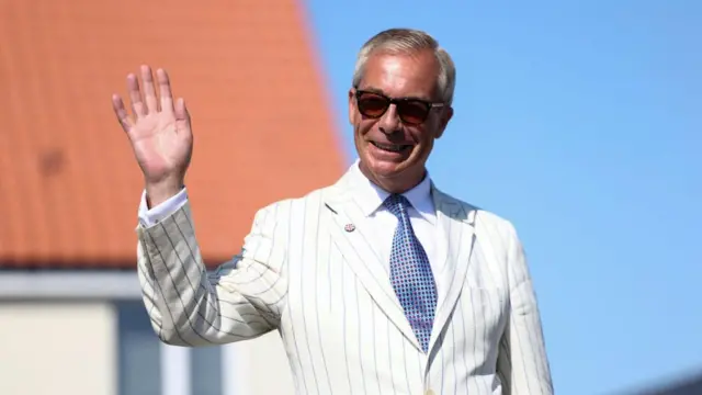 Nigel Farage on polling day, wearing a white suit and sunglasses