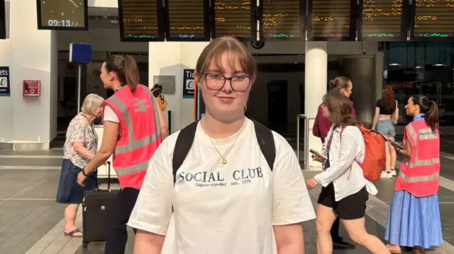 Phoebe stands in a relatively quiet Birmingham New Street station