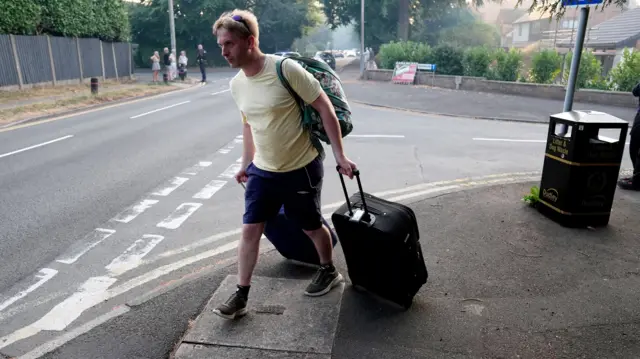 A resident leaves their home after a fire broke out in the Stourbridge area
