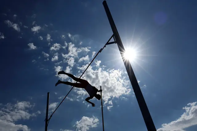 Antoine Ferranti of Team France (R) reacts in the shade as he awaits his turn in the Pole Vault leg