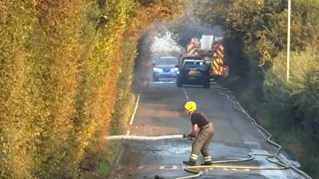 Fire crews working on Racecourse Lane, Stourbridge, near properties damaged by a major fire