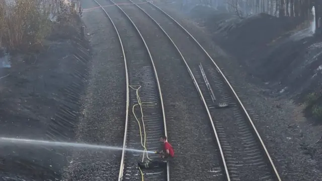 A firefighter on the railway line between Hagley and Stourbridge Junctio