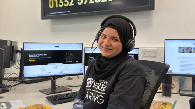 A woman working at a university desk