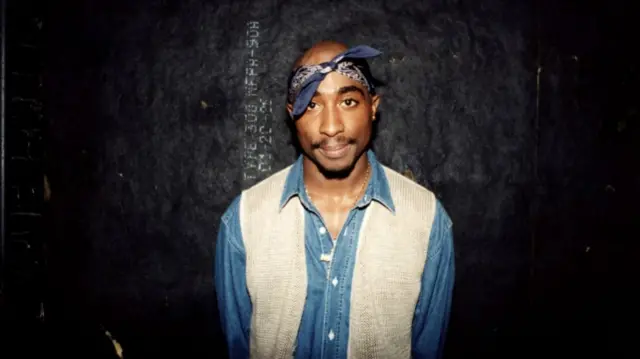 Rapper Tupac Shakur poses for photos backstage after his performance at the Regal Theater in Chicago, Illinois in March 1994.