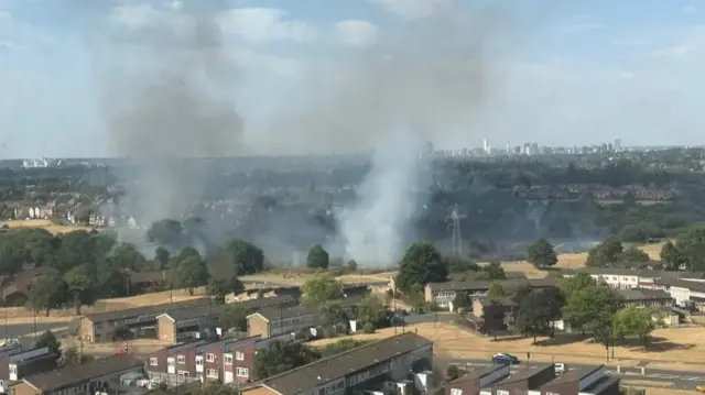 Smoke seen billowing over a field