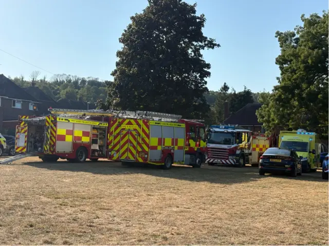 Fire engines in a field.