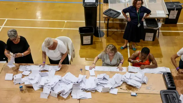 Election workers sorting through ballots for the Clacton by-election