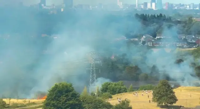Smoke seen billowing over a field