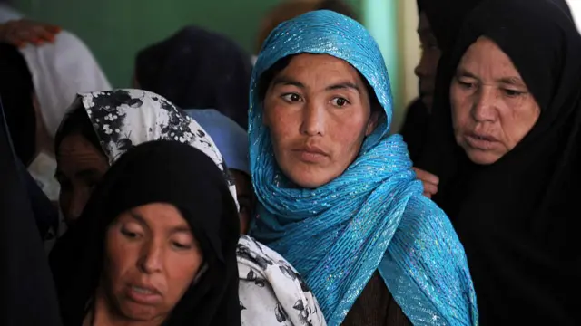 Four Afghan women in a line, wearing Hijabs which show their face