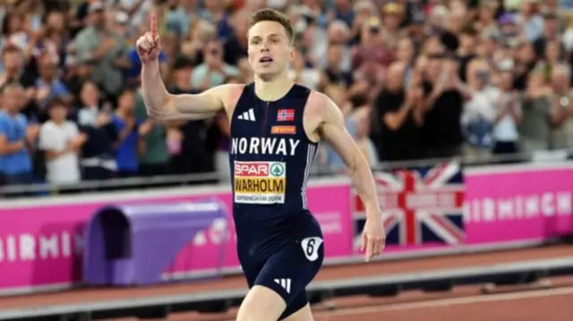 Warholm celebrating