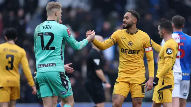 Blackburn goalkeeper Balazs Toth shakes hands with Wolves' Matheus Cunha after an FA Cup fourth-round tie in February 2025