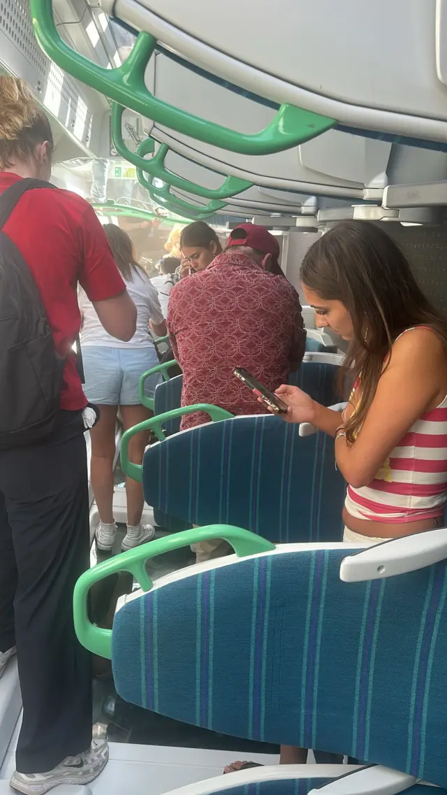 Passengers stand on windows and seats inside the affected train.