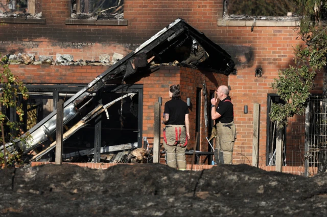 Fire crews inspect a burned out Stourbridge property