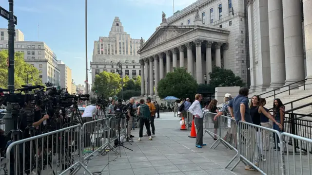 The view from outside a Manhattan federal court. Metal barricades are set up with press lining the street