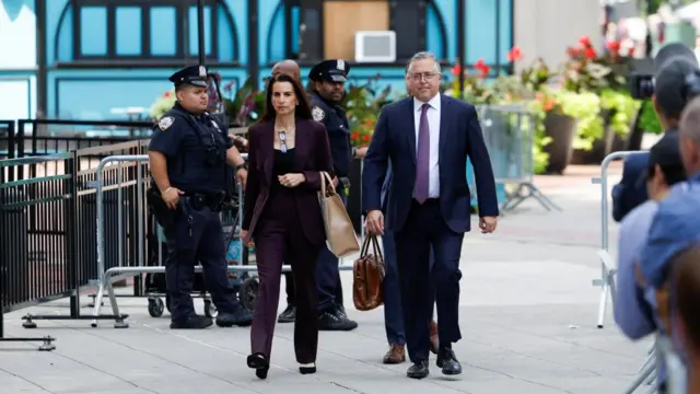 Defense lawyers Karen Friedman Agnifilo and Marc Agnifilo walk outside court