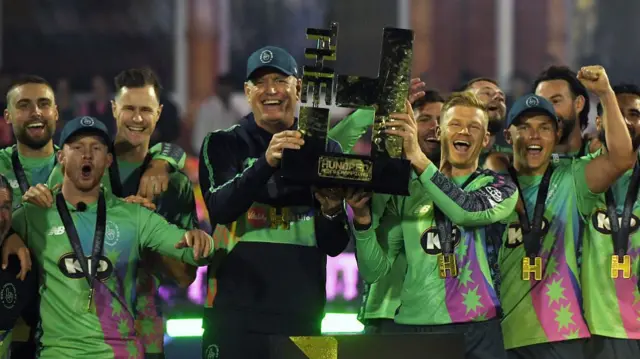 Tom Moody and Sam Billings hold the trophy after Oval Invincibles won The Hundred Final match between Oval Invincibles Men and Trent Rockets Men