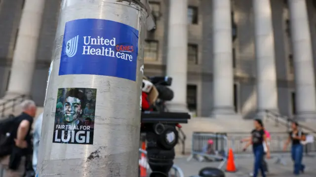 Stickers are seen outside a federal court on the day of Mangione's hearing