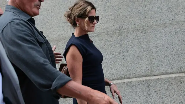 Paulette Thompson, the widow of slain healthcare boss Brian Thompson, leave court in a dark blue dress and sunglasses