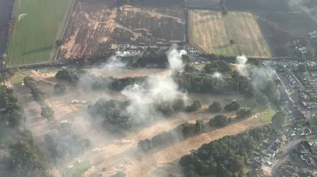 Stourbridge Golf Club from above showing smoke still pouring from the dry and brown grounds.
