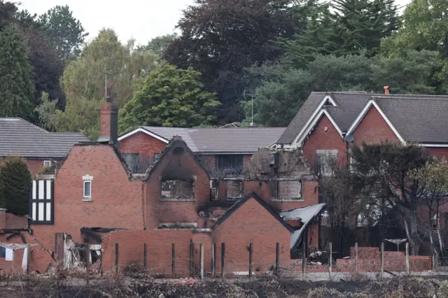 a house with no roof, singed brick walls