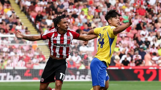 Romelle Donovan (left) challenges for the ball