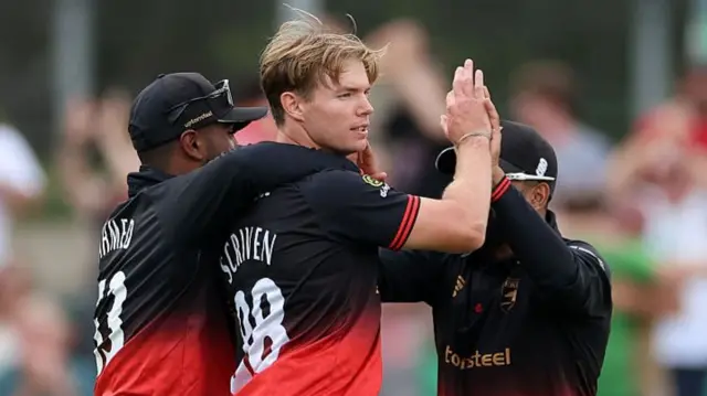 Tom Scriven celebrates the wicket of Jack Haynes