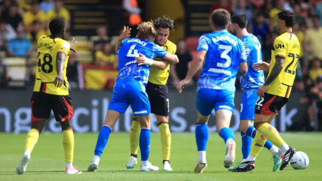 Flynn Downes and Othmane Maamma clash as players from both teams surround them