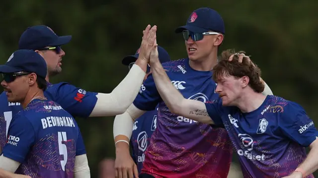 Luke Robinson celebrates his first wicket