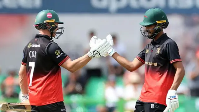 Ben Cox touches gloves with Hamza Shaikh
