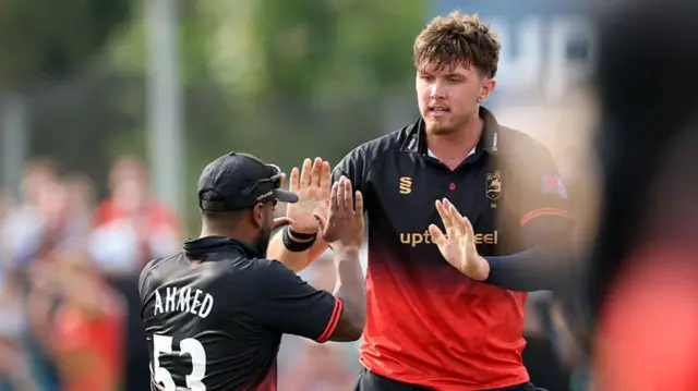 Alex Green celebrates the wicket with Rehan Ahmed