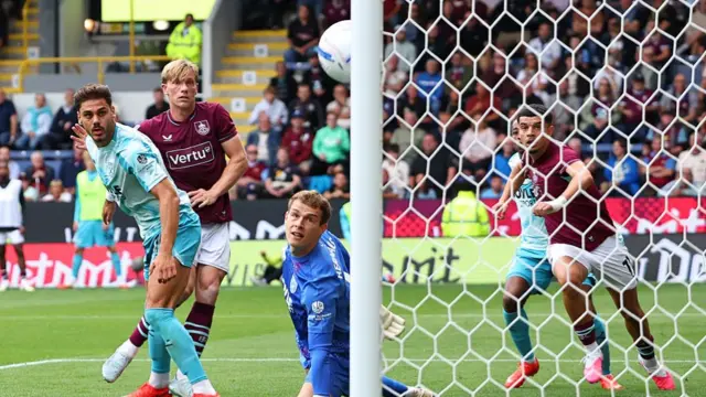 Zian Flemming (centre) watches as the ball drifts towards the post