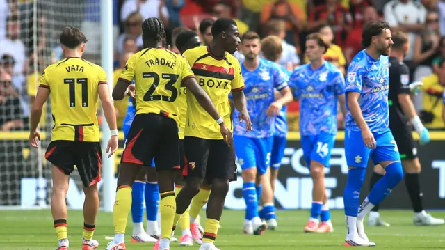 Watford players (left) clap hands to celebrate win
