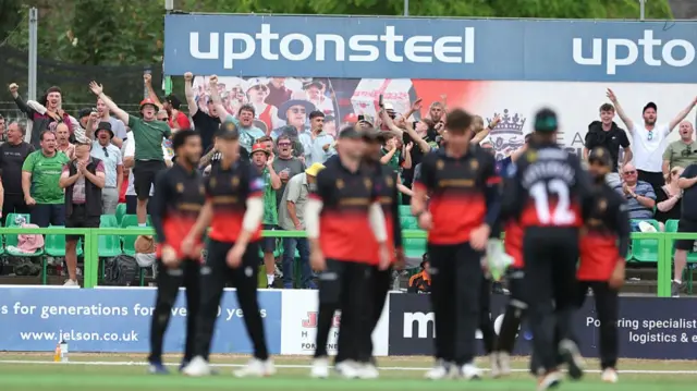 Leicestershire fans and players celebrate Liam Patterson-White's wicket