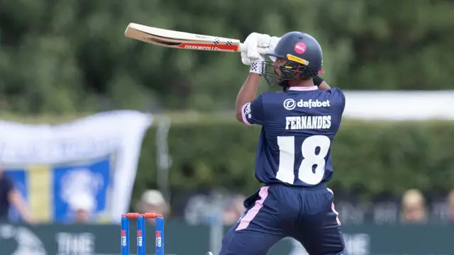 Nathan Fernandes cuts a ball away