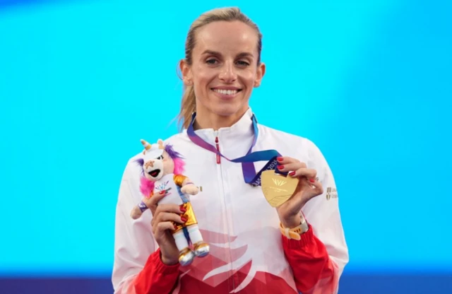 Georgia Hunter Bell of England celebrates with the gold medal