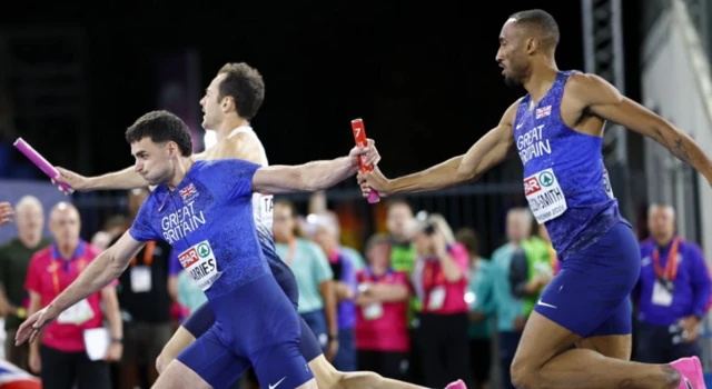 Matthew Hudson-Smith (L) passes the relay baton