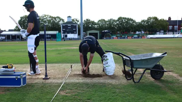 Ground staff prepare the wicket at Leicester