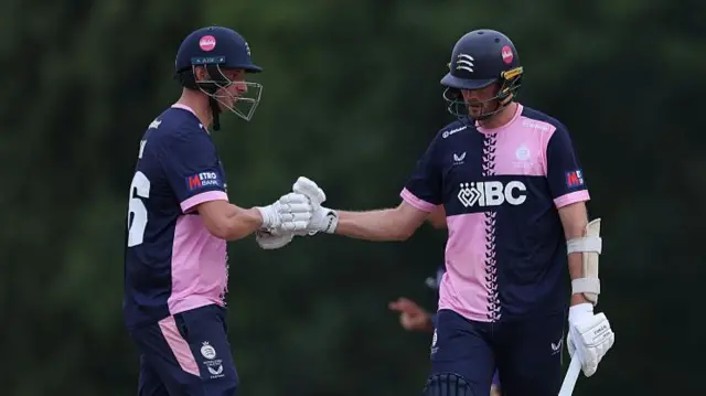 Luke Hollman and Tom Helm touch gloves