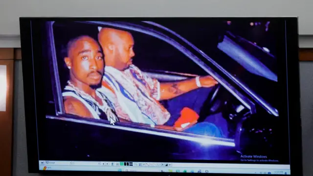 A 1996 photo of rapper Tupac Shakur (L) and Marion "Suge" Knight is displayed during the trial