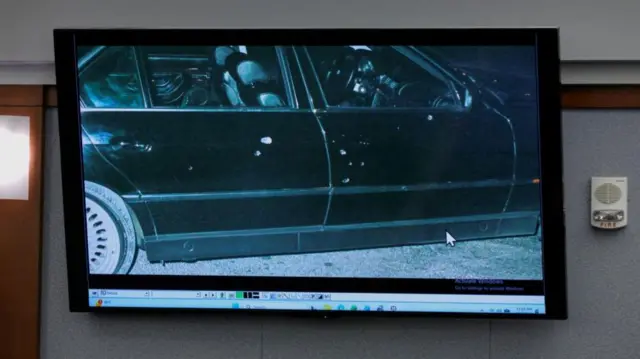 The black car with bullet holes